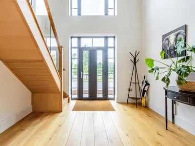a hallway with wooden floors and a staircase with glass doors at 5 Bed in Llanymynech oc-80686 in Llanymynech