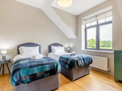 a bedroom with two beds and a window at 5 Bed in Llanymynech oc-80686 in Llanymynech