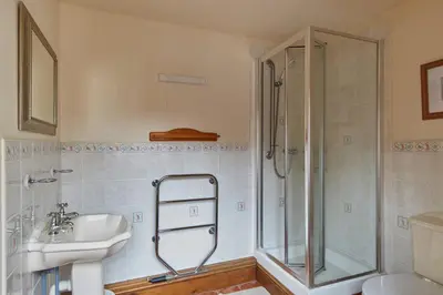 a bathroom with a shower and a sink at The Long Barn in Church Stretton