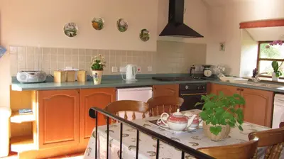 a kitchen with a table with chairs and a table sidx sidx sidx at The Long Barn in Church Stretton