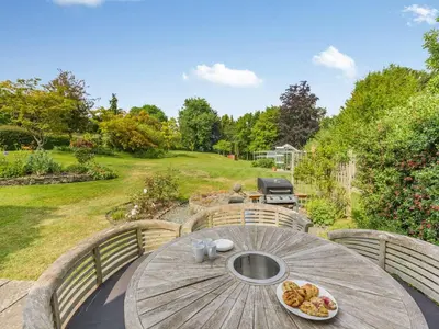 a wooden table with a plate of food on it at The Barrels at Leintwardine in Leintwardine