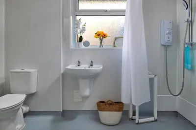 a white bathroom with a sink and a toilet at Finest Retreats - 37 Bro Enddwyn in Dyffryn