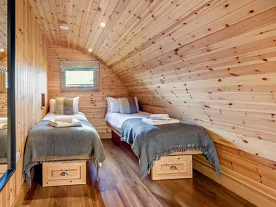 a room with two beds in a log cabin at 2 Bed in Rhayader oc-90276 in Saint Harmon