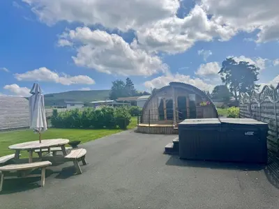 a greenhouse and a picnic table and an umbrella at 2 Bed in Rhayader oc-90276 in Saint Harmon