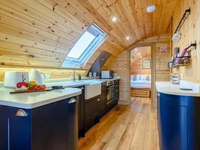 a kitchen in a log cabin with a window at 2 Bed in Rhayader oc-90274 in Saint Harmon