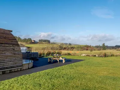 a picnic table on the side of a building in a field at 2 Bed in Rhayader oc-90274 in Saint Harmon