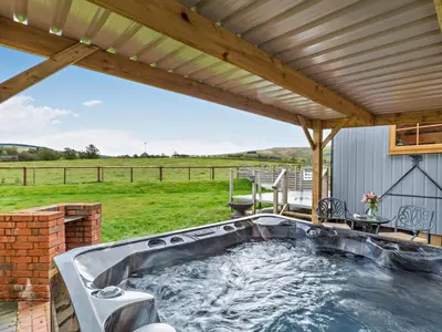 a hot tub on a patio with a roof at 1 Bed in Rhayader oc-90285 in Saint Harmon