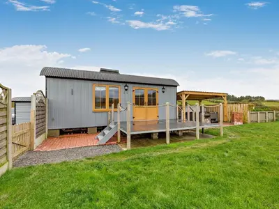 a tiny house with a deck and a playground at 1 Bed in Rhayader oc-90285 in Saint Harmon