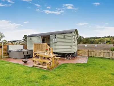 a tiny caravan with a deck and a grill at 1 Bed in Rhayader oc-90277 in Saint Harmon