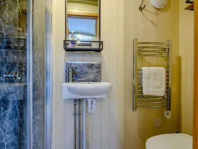 a bathroom with a sink and a toilet and a mirror at 1 Bed in Rhayader oc-90284 in Saint Harmon