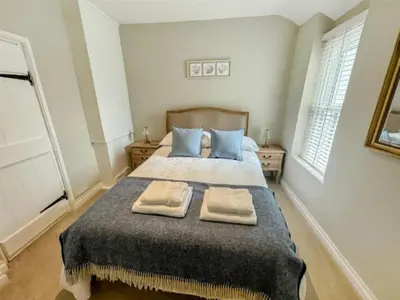 a bedroom with a bed with two towels on it at The Retreat - 2 bed cottage in Aberdovey in Aberdyfi