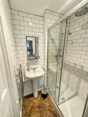 a bathroom with a sink and a shower at The Retreat - 2 bed cottage in Aberdovey in Aberdyfi