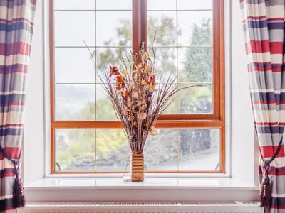 a vase of flowers sitting on a window sill at 3 Bed in Corwen oc-90459 in Corwen