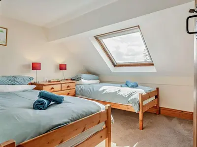 a bedroom with two beds and a window at 4 Bed in Painscastle 90375 in Builth Wells