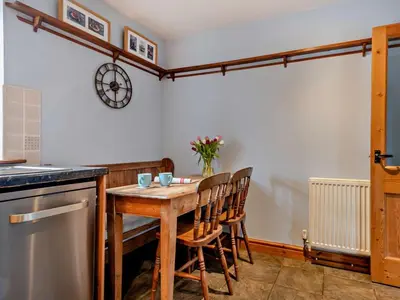 a kitchen with a wooden table and chairs at 2 Bed in Brecon oc-91085 in Llangorse