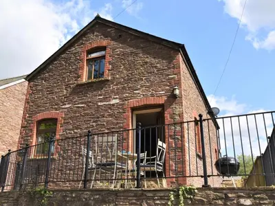 a brick house with a balcony with a fence at 2 Bed in Brecon oc-91085 in Llangorse
