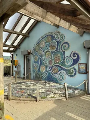 a wall with a mural on the side of a building at Little Curlew, Ynyslas, Borth in Borth