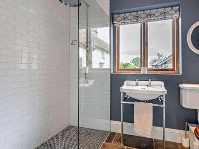 a bathroom with a sink and a shower at 4 Bed in Hereford oc-92039 in Clyro