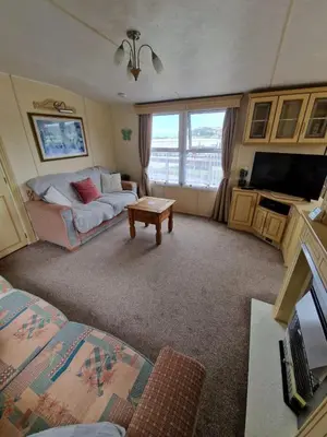 a living room with a couch and a table at Haven on the Hill 2 Bed Caravan with Town Views of Aberystwyth F7 in Aberystwyth