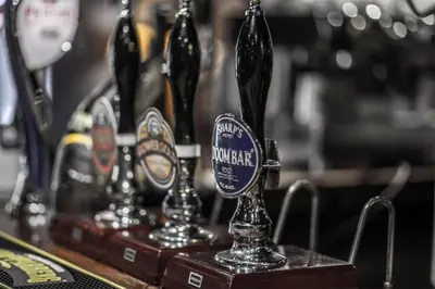 a group of bottles of beer on a bar at The Kings Head Inn in Llandovery