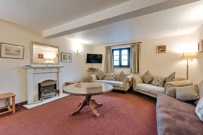 a living room with a couch and a table at Finest Retreats - The Walton in Onibury