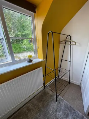 a room with a shelf and a window at Beech Cottage with Clun Castle View in Clun