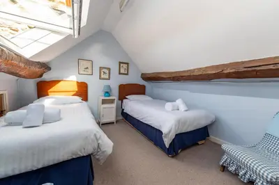 a bedroom with two beds and a window at Toad Hall in Ludlow