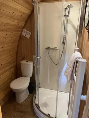a bathroom with a shower and a toilet in a cabin at Mountain Edge Resort Mega pod 3 with Hot Tub in Church Stretton