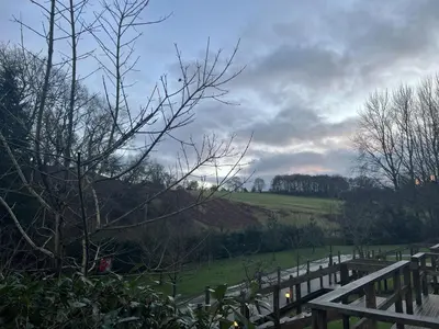a wooden fence with a field in the background at Mountain Edge Resort Mega pod 3 with Hot Tub in Church Stretton