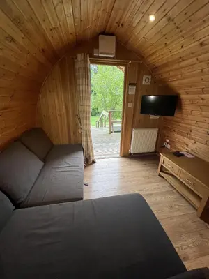 a bedroom with a bed and a tv in a room at Mountain Edge Resort Mega pod 4 with Hot Tub in Church Stretton