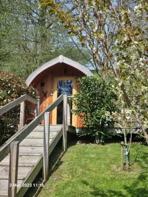 a small wooden cabin with a ramp leading to it at Mountain Edge Resort Mega pod 6 with Hot Tub in Church Stretton