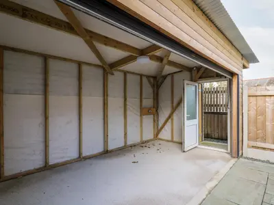 an empty garage with a door in a house at Afonwy House in Rhayader