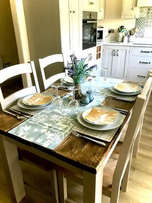 a dining room table with plates of food on it at Leverets - Squirrel Lane Lodges Ludlow in Ludlow