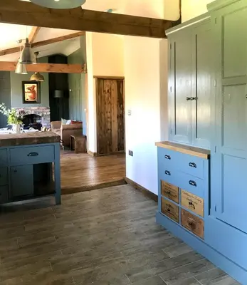 a kitchen with blue cabinets and a counter top at The Nut House - Squirrel Lane Lodges Ludlow in Ludlow