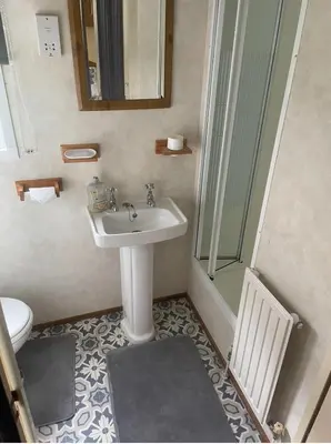 a bathroom with a sink and a shower at Spacious Luxury Escape with Sea Views and Pet Friendly at Clarach Bay in Aberystwyth