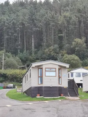 a small house sitting on the side of a road at Spacious Luxury Escape with Sea Views and Pet Friendly at Clarach Bay in Aberystwyth