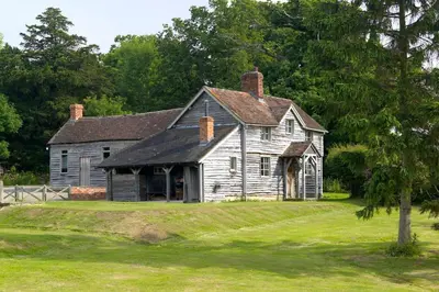 an old house sitting on a grass field at Spacious Holiday Cottage with Scenic Views in Church Stretton