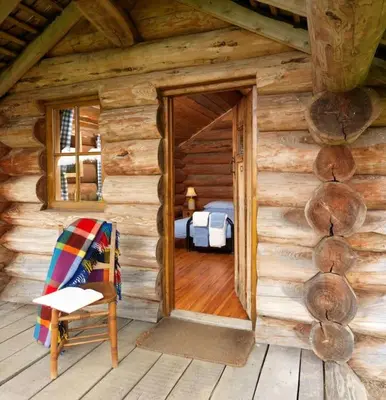 a log cabin with a door leading to a bedroom at Spacious Holiday Cottage with Scenic Views in Church Stretton