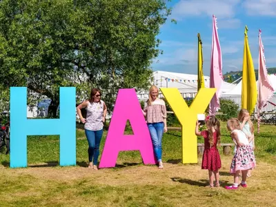 a group of children standing in front of a sign that reads new age at 2 Bed in Hay-on-Wye 93221 in Hay-on-Wye