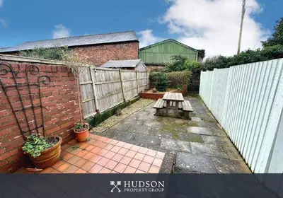 a backyard with a wooden fence and a bench at Town Centre Period Property by Shrewsbury Abbey in Shrewsbury