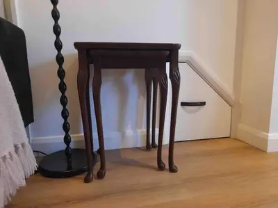 a wooden end table sitting next to a staircase at The Walkers' Cwtch in Ffestiniog