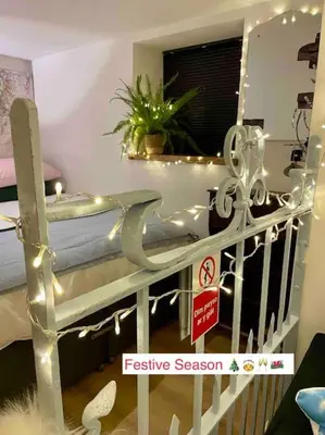 a room with a bed with a no smoking sign at The Walkers' Cwtch in Ffestiniog
