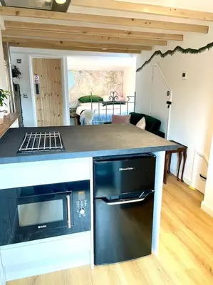 a kitchen with a counter top with a stove top oven at The Walkers' Cwtch in Ffestiniog