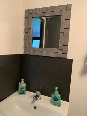 a bathroom with a mirror and a sink with two soap at Lakeside retreat - Lodge 2F caer beris holiday park - no commercial vehicles allowed on site in Builth Wells