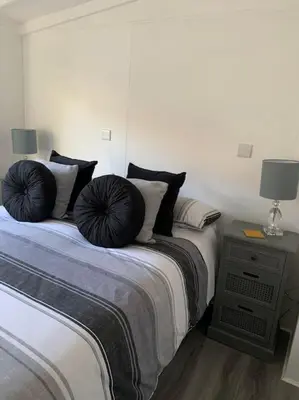 a bedroom with a bed with two pillows on it at Lakeside retreat - Lodge 2F caer beris holiday park - no commercial vehicles allowed on site in Builth Wells
