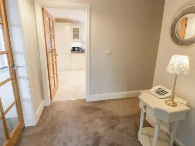 a hallway with a table and a lamp at Ty Ni in Dyffryn