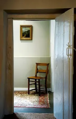 a room with a chair and a table in a room at The Castle, Capel-y-Ffin, The Black Mountains in Abergavenny