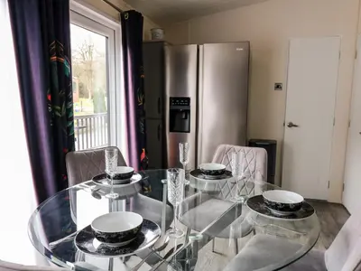 a glass table with plates on top of it in a kitchen at The Hideout in Llanina