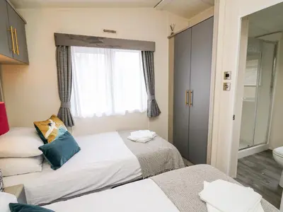 a bedroom with two beds and a window at The Hideout in Llanina