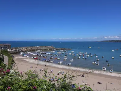 a bunch of boats in the water at a beach at The Hideout in Llanina